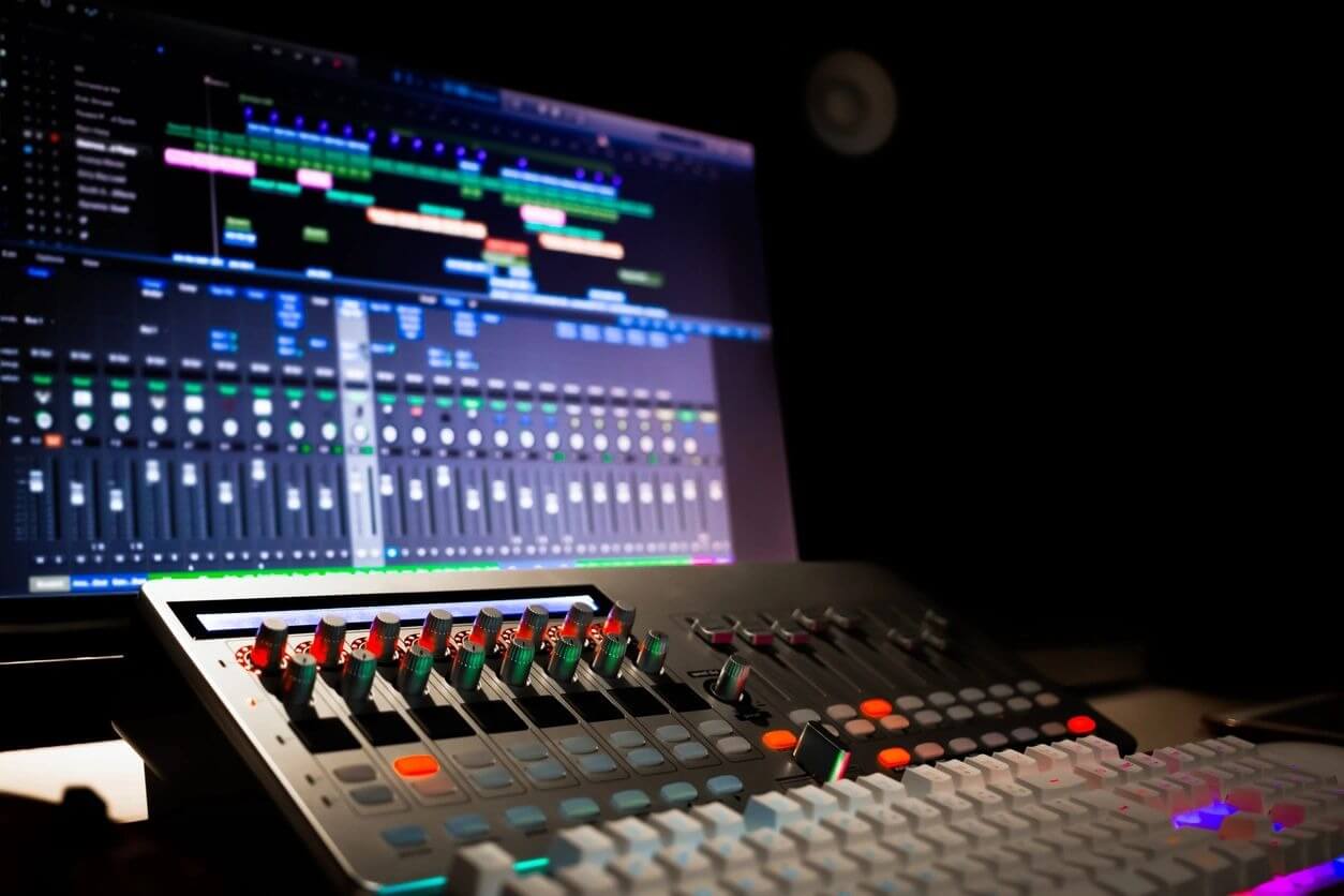 A close up of an audio mixing board